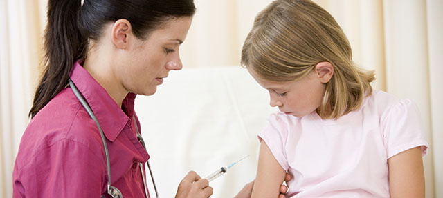 photo - Doctor Giving Vaccination to Young Girl